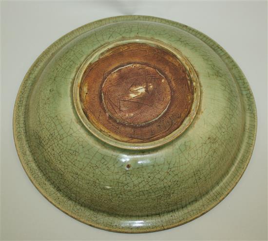 A Chinese Longquan celadon dish, 15th century, 30.5cm, rim crack and crazing to glaze